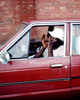 Musician in Car in New Orleans Harmonica player 